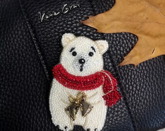 A brooch of a New Year's white polar bear