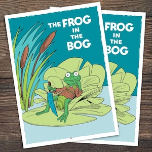 May include: Two green and white postcards with the text "The Frog in the Bog" and "Frog in the Bog". The postcard on top has a cartoon frog sitting on a lily pad holding a sword.