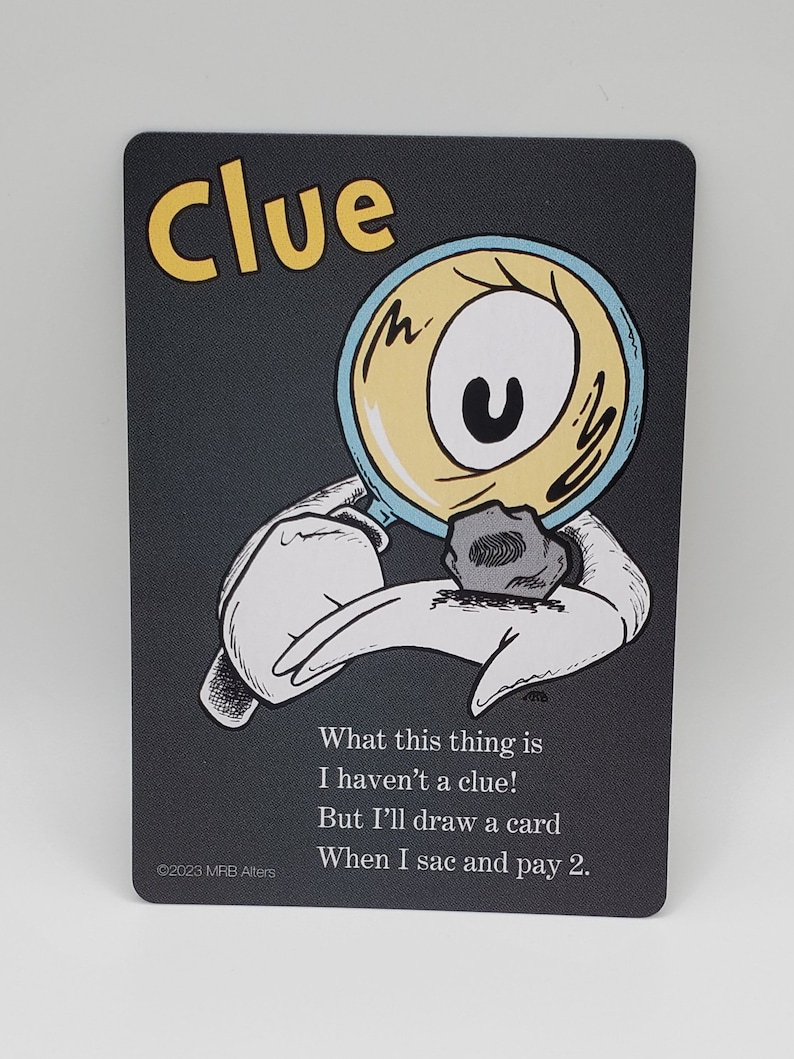 May include: A black card with a cartoon illustration of a hand holding a magnifying glass over a small rock. The text on the card reads "Clue" in yellow letters and "What this thing is I haven't a clue! But I'll draw a card When I sac and pay 2." in white letters.