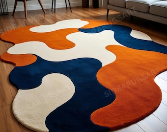 Alfombra de lana tejida a mano, diseño abstracto irregular en azul marino y naranja quemado.