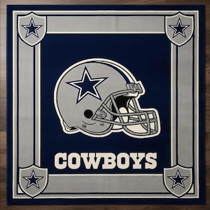 Hand tufted wool Dallas Cowboys inspired football area rug in navy blue and silver, featuring a helmet graphic, displayed in a modern luxury living room.