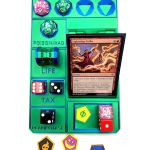 May include: A green and blue Commander Damage and Life counter for Magic: The Gathering. Includes dice, tokens, and a card. The card reads "Lightning Strike".