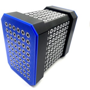 May include: A rectangular black and blue object with numerous silver screws arranged in a grid pattern. The object has a blue frame and a black body. The screws are evenly spaced across the surface.