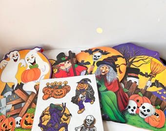 May include: A set of Halloween decorations featuring ghosts, witches, and pumpkins. The decorations are made of paper and are designed to be hung or displayed. The set includes a ghost with a pumpkin, a witch with a broom, and a pumpkin with a jack-o'-lantern face.
