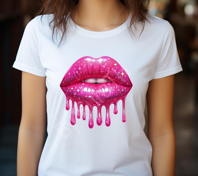 May include: White t-shirt featuring a large, vibrant pink lip design. The lips have a sparkling, glittery texture with dripping liquid effect. The design includes white teeth and a glossy finish, creating a bold and eye-catching graphic.