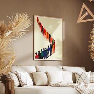 May include: A framed print of a colorful abstract design featuring a line of people in various shades of blue, red, yellow, and green. The print is hanging on a beige wall above a white couch with pillows.