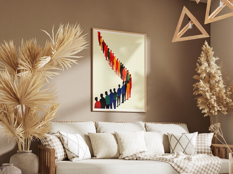 May include: A framed print of a colorful abstract design featuring a line of people in various shades of blue, red, yellow, and green. The print is hanging on a beige wall above a white couch with pillows.