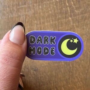 May include: Purple sticker with the text "DARK MODE" in black with yellow stars and a yellow crescent moon.