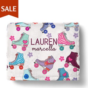 A white towel with a colorful pattern of roller skates and flowers printed on it.