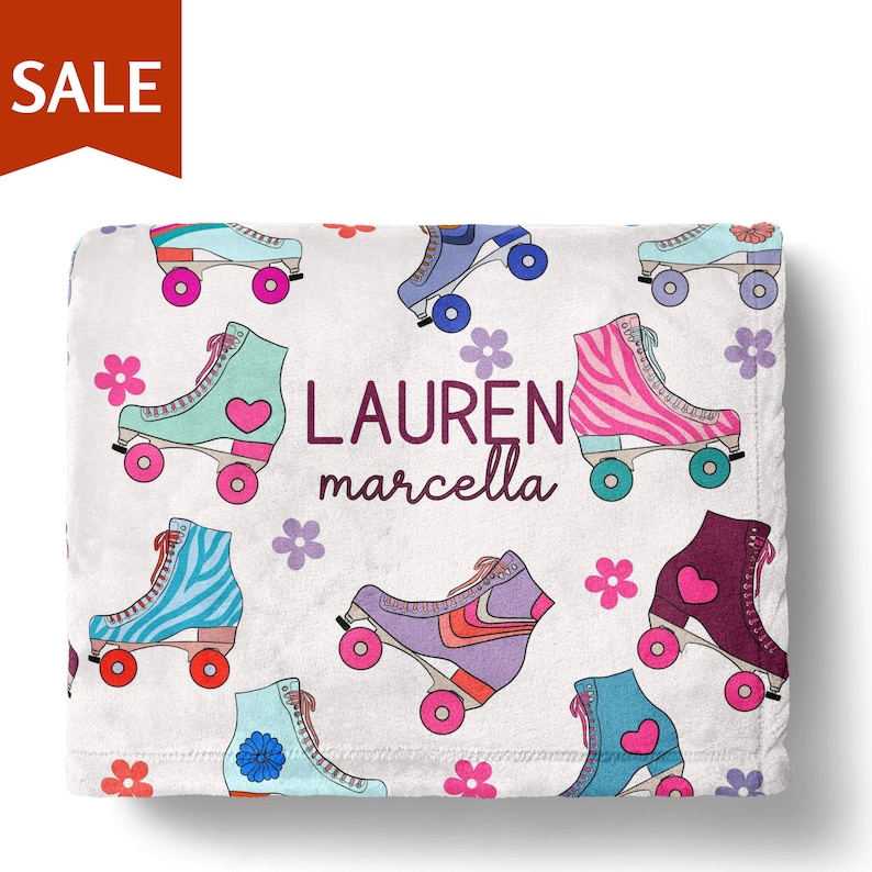 A white towel with a colorful pattern of roller skates and flowers printed on it.