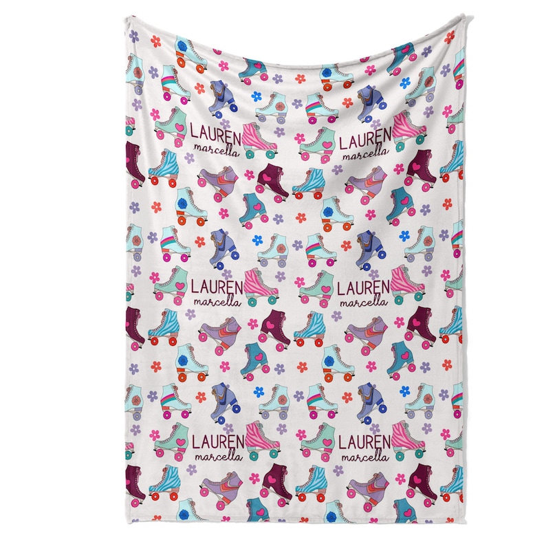 a white blanket with a repeating pattern of roller skates and flowers printed on it.