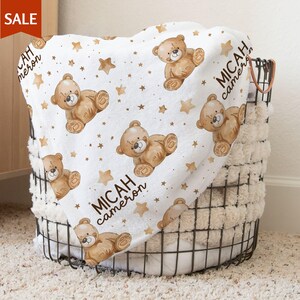 a baby blanket with a teddy bear on it