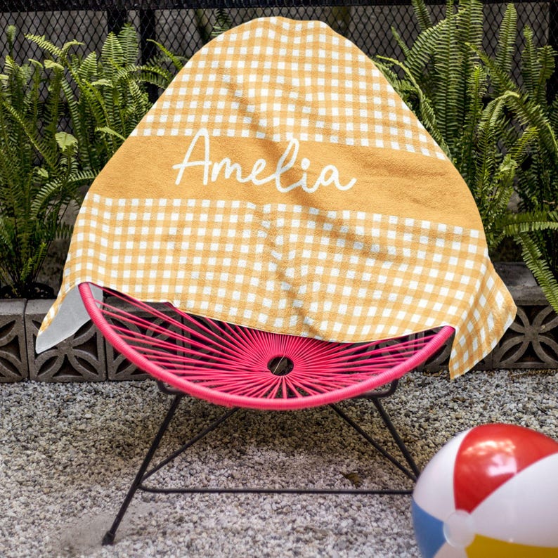 a pink chair with a yellow and white cover on it