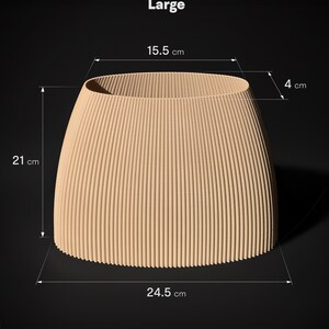 May include: A large, beige, corrugated cardboard planter with dimensions of 15.5 inches wide, 21 inches tall, and 24.5 inches long. The planter is shown on a black background.
