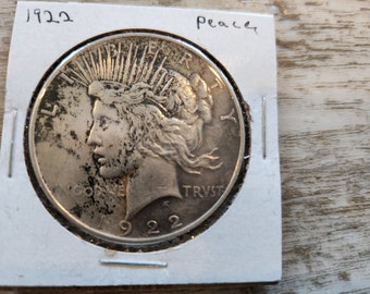 1922 Peace Silver Dollar is Almost Uncirculated  and is from Philadelphia Mint. This is inexpensive way to start collecting silver dollars.