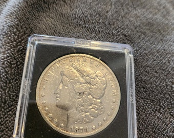 This 1878P 7 Tail Feather 1878 Reverse Morgan Silver Dollar is a prime example of Fine conditioned coin and is from the Philadelphia Mint.