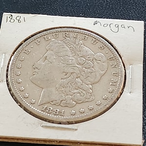 This 1881 O Morgan Silver Dollar is in AU condition and is from New Orleans. It is an inexpensive way to start collecting silver dollars. image 1