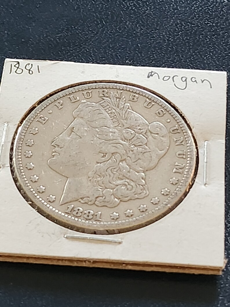 This 1881 O Morgan Silver Dollar is in AU condition and is from New Orleans. It is an inexpensive way to start collecting silver dollars. image 1