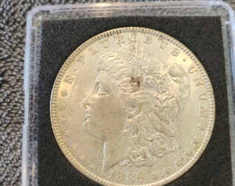 1886 P Morgan Silver Dollar is  uncirculated and is from the Philadelphia mint. It's an inexpensive way to start collecting  silver dollars.
