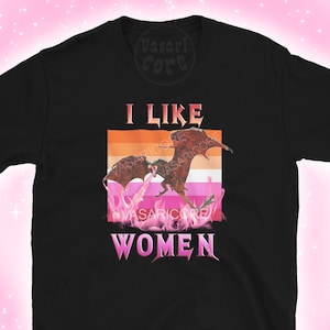 May include: Black t-shirt with a graphic of two dragons fighting in front of a pink, orange, and white lesbian pride flag. The text "I LIKE WOMEN" is below the graphic.