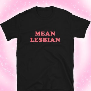 May include: Black t-shirt with the text "MEAN LESBIAN" in pink letters.