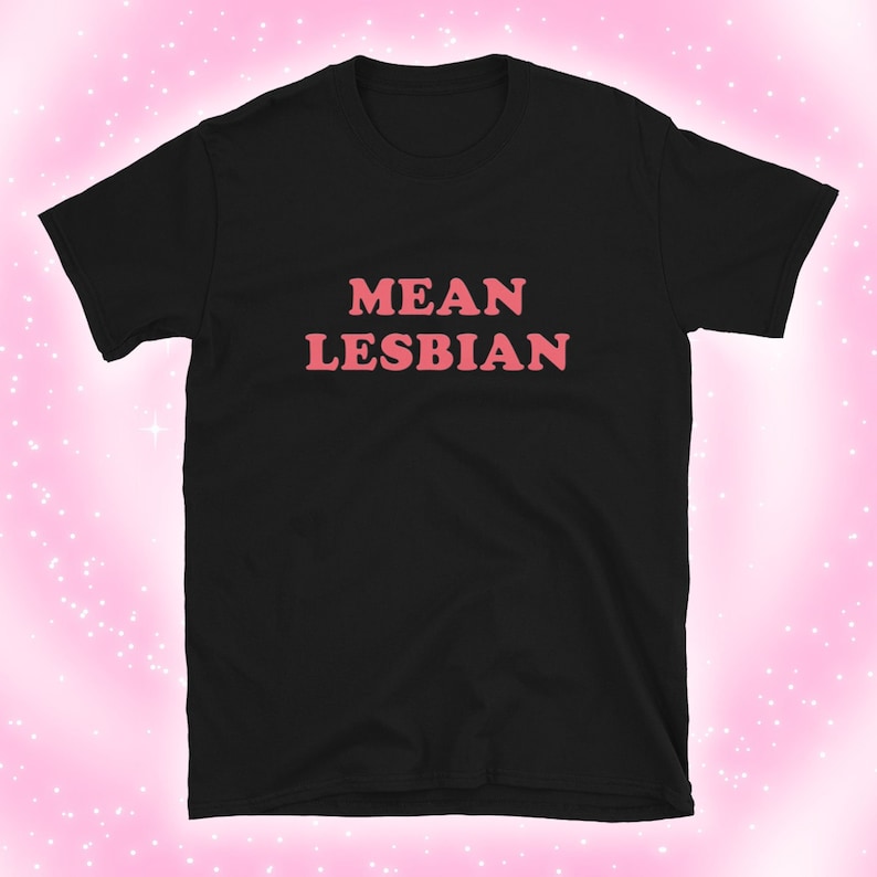 May include: Black t-shirt with the text "MEAN LESBIAN" in pink letters.