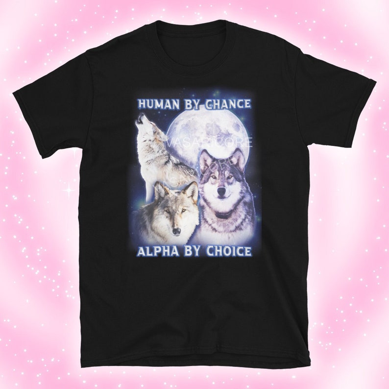 May include: Black t-shirt with a graphic of three wolves howling at the moon. The text "HUMAN BY CHANCE ALPHA BY CHOICE" is printed on the shirt.