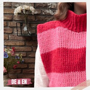 May include: A pink and red striped knitted vest with a high neckline. The vest is made of a soft, fuzzy yarn.