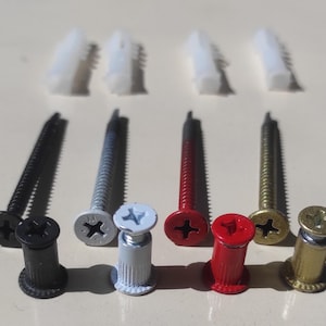 May include: Assortment of screws and anchors in black, silver, red, and gold. The screws have a Phillips head and the anchors are made of plastic.