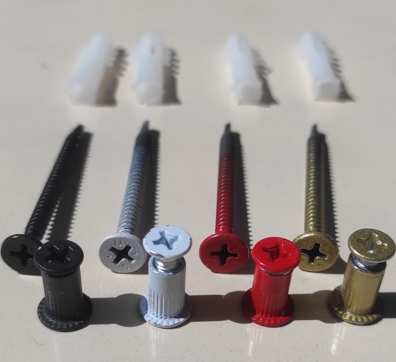 May include: Assortment of screws and anchors in black, silver, red, and gold. The screws have a Phillips head and the anchors are made of plastic.