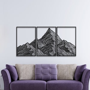 May include: A black metal wall art sculpture depicting a mountain range with a minimalist line art design. The sculpture is divided into three sections and is mounted on a white wall.