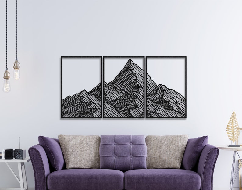 May include: A black metal wall art sculpture depicting a mountain range with a minimalist line art design. The sculpture is divided into three sections and is mounted on a white wall.