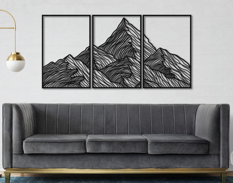 May include: Black and white mountain range wall art made of metal. The art is divided into three sections and features a stylized mountain range with a layered design.