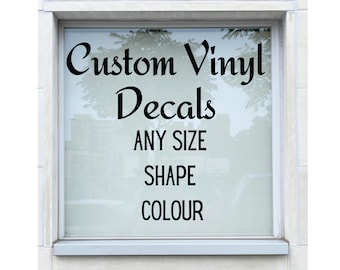 May include: A window with a sign that reads "Custom Vinyl Decals ANY SIZE SHAPE COLOUR".