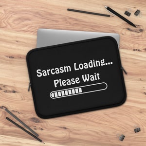 May include: Black laptop sleeve with white text that reads "Sarcasm Loading... Please Wait" and a progress bar.