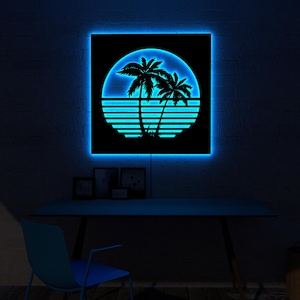 May include: A square, black wall art piece with a neon blue border. The art features a silhouette of palm trees and a sunset design. The piece is illuminated with a bright blue light, creating a vibrant and eye-catching display.
