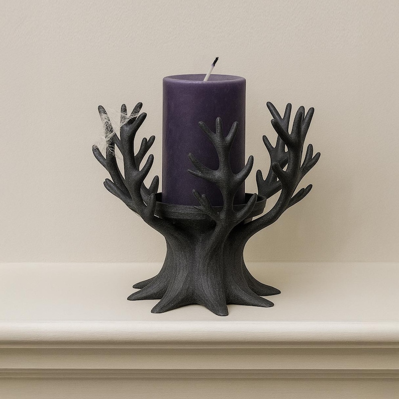 May include: A black, tree-shaped candle holder with a dark purple pillar candle. The candle holder has a textured finish and a circular base to hold the candle. The candle is unlit and has a white wick.