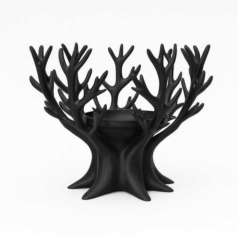 May include: A black decorative bowl with a tree-like design. The bowl has a central basin surrounded by multiple branches, creating a unique aesthetic. The bowl is made of a solid, dark material and is suitable for home decor.