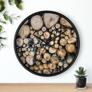 May include: A black clock with a round face featuring a wood-grain design. The clock face is covered in a variety of wood pieces, creating a unique and rustic look.