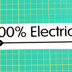 May include: White sticker with black text that reads "100% Electric" and a black silhouette of an electrical plug with a cord.