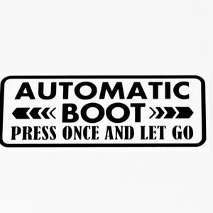 May include: A black and white sticker with a rectangular shape and rounded corners. The text reads "AUTOMATIC BOOT" with arrows, and "PRESS ONCE AND LET GO" in a bold, sans-serif font.