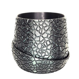 May include: A black planter with a geometric pattern. The planter is made of a textured material and has a rounded shape.