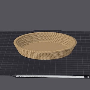 May include: A woven brown basket with a round shape and a smooth, flat bottom. The basket is made of natural materials and has a rustic appearance.