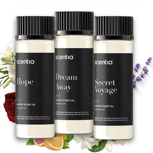 May include: Three glass bottles of luxury scent oil with black caps and labels. The labels read "Hope", "Dream Away", and "Secret Voyage". Each bottle contains 20ml of oil. Floral accents surround the bottles.