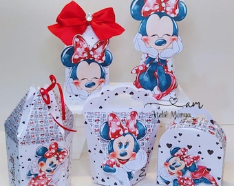 May include: A collection of Minnie Mouse-themed party favor boxes and decorations. The boxes are white with black heart and bow patterns, featuring Minnie Mouse illustrations. A large red bow adorns one box. The decorations are ideal for a birthday party.