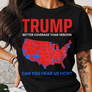May include: Black t-shirt with a red and blue map of the United States and the text "TRUMP BETTER COVERAGE THAN VERIZON CAN YOU HEAR US NOW?"