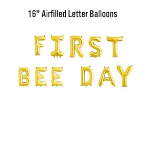 May include: Gold air-filled letter balloons spelling "FIRST BEE DAY" on a white background. The balloons are 40.6 cm in height, ideal for a first birthday party. The text "16" Airfilled Letter Balloons" is at the top.