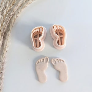 May include: Two plastic baby foot cookie cutters and two fondant baby feet.