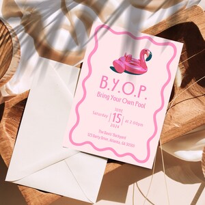 May include: A pink invitation with a flamingo float illustration, the text "B.Y.O.P. Bring Your Own Pool", and event details for June 15, 2024, at 2:00 PM. The invitation is on a wooden surface with an envelope.