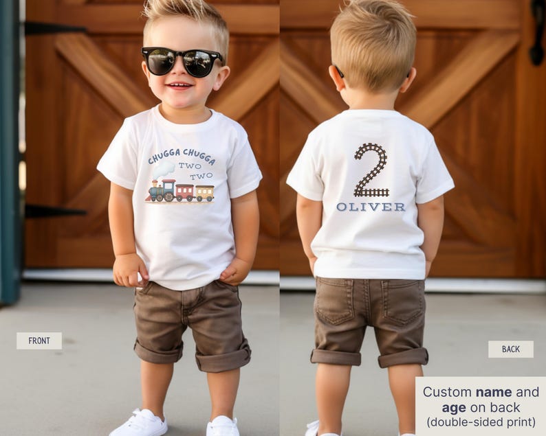 May include: A white t-shirt with a train graphic and the text "CHUGGA CHUGGA TWO TWO" on the front. The back of the shirt features the number "2" and the name "OLIVER". The child is wearing brown shorts and white sneakers.